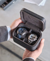 A man showcasing the TAWBURY Fraser 2 Watch Travel Case in a sleek leather watch travel case.